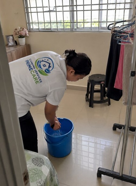 Cleaning Services Primecare cleaner doing housekeeping work in a bedroom