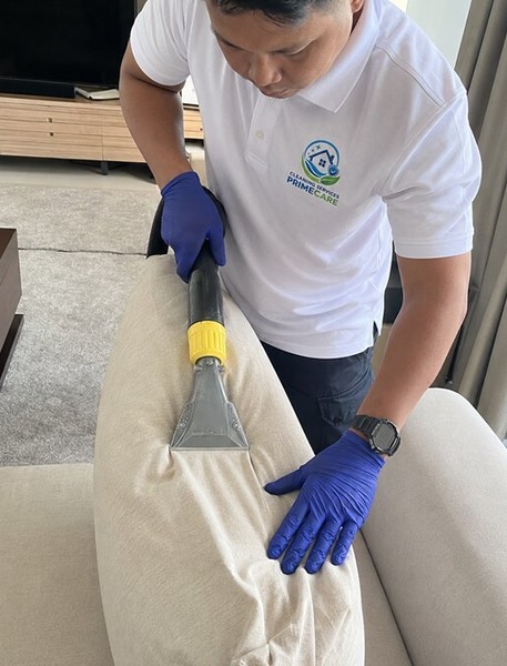 Sofa cleaning service in Malaysia — Cleaning Services Primecare technician steam extracting a sofa